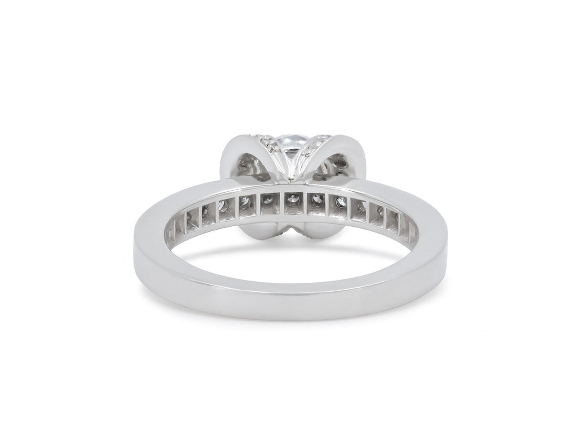 Platinum diamond ring with ribbon setting and diamond shoulders