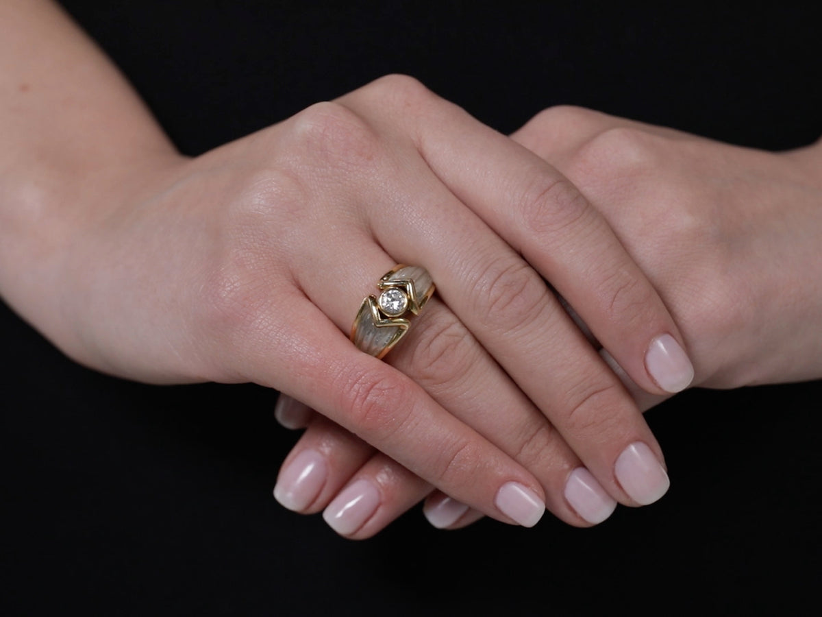Hand wearing an 18K gold diamond and rock crystal ring