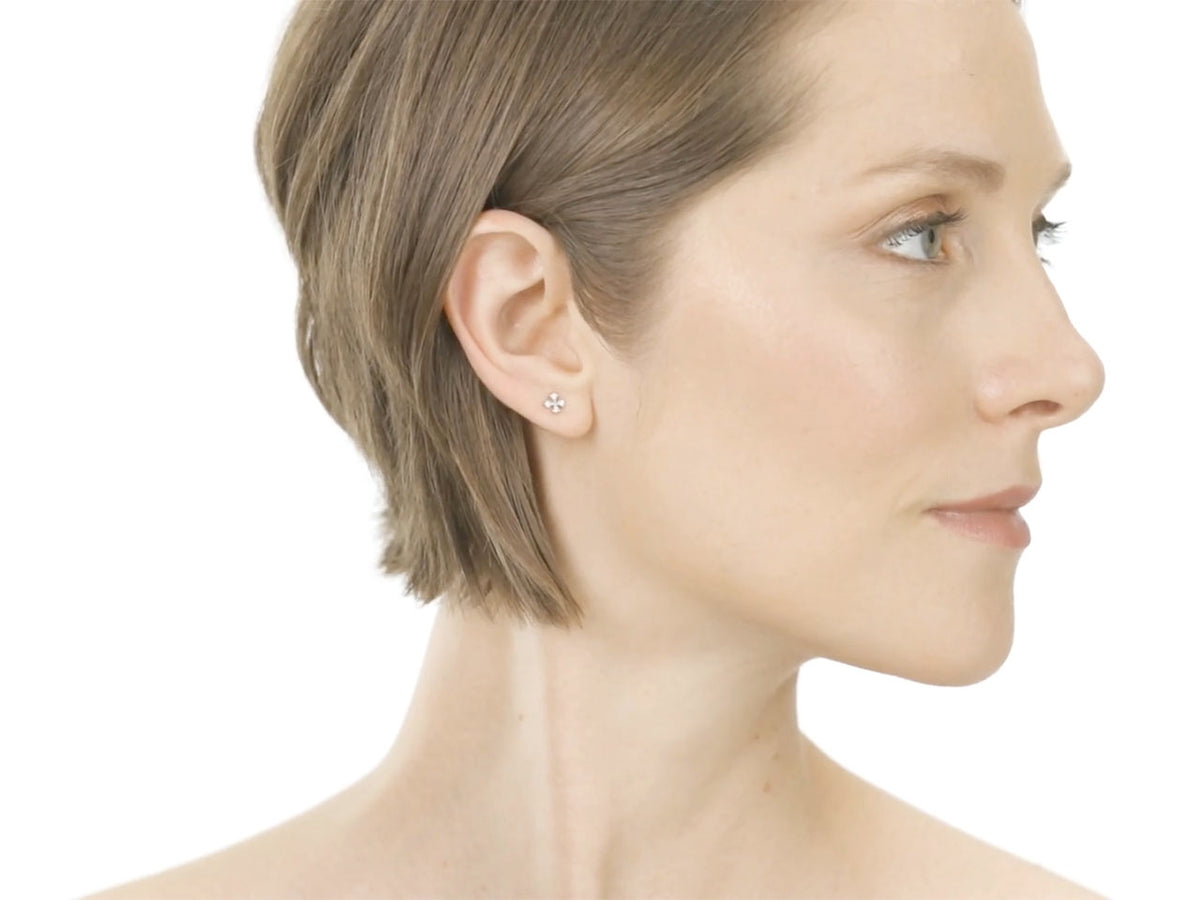 Woman wearing a diamond cross stud earring