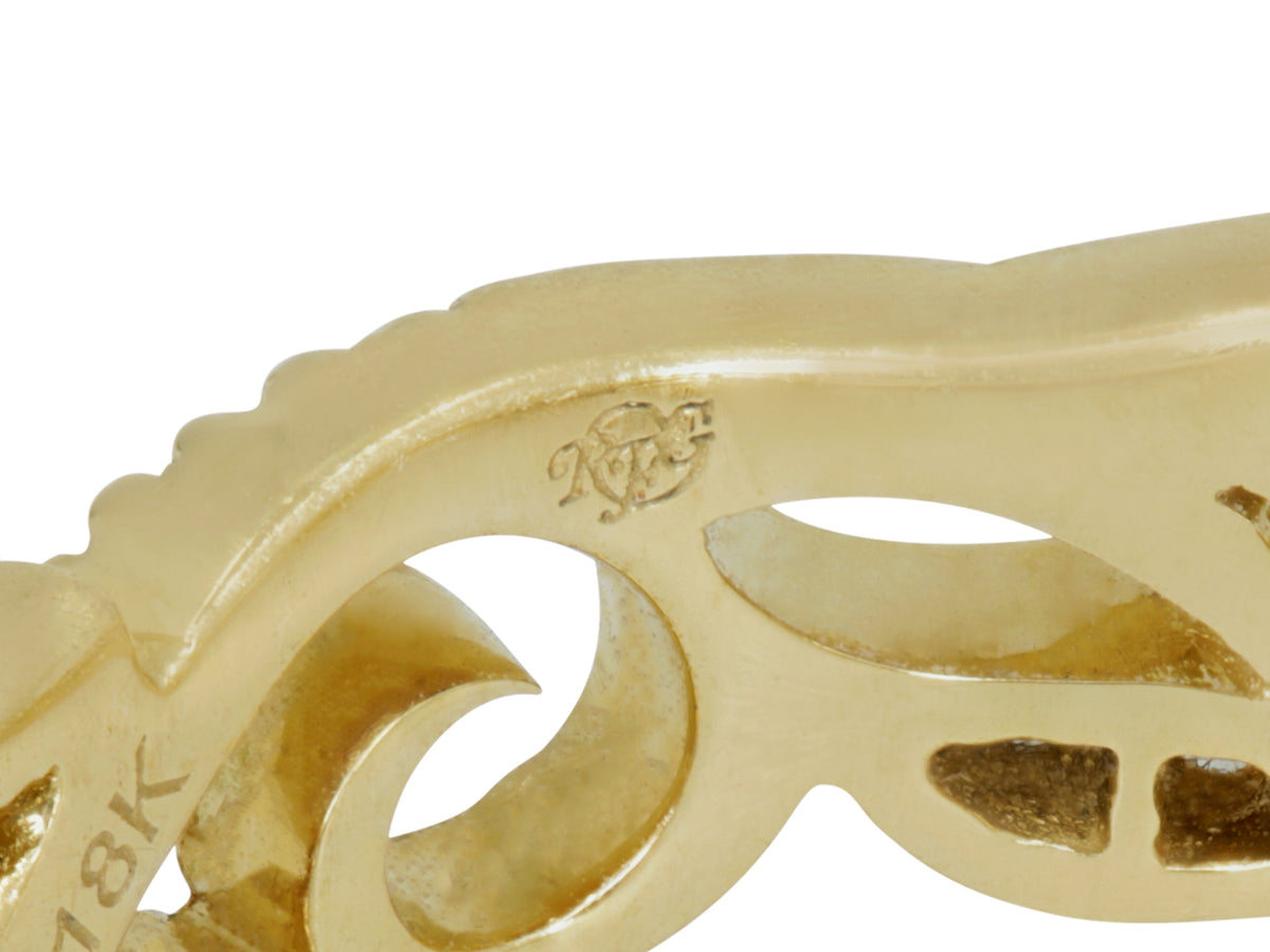 Close up of an 18K gold ring with sculpted ivy motifs