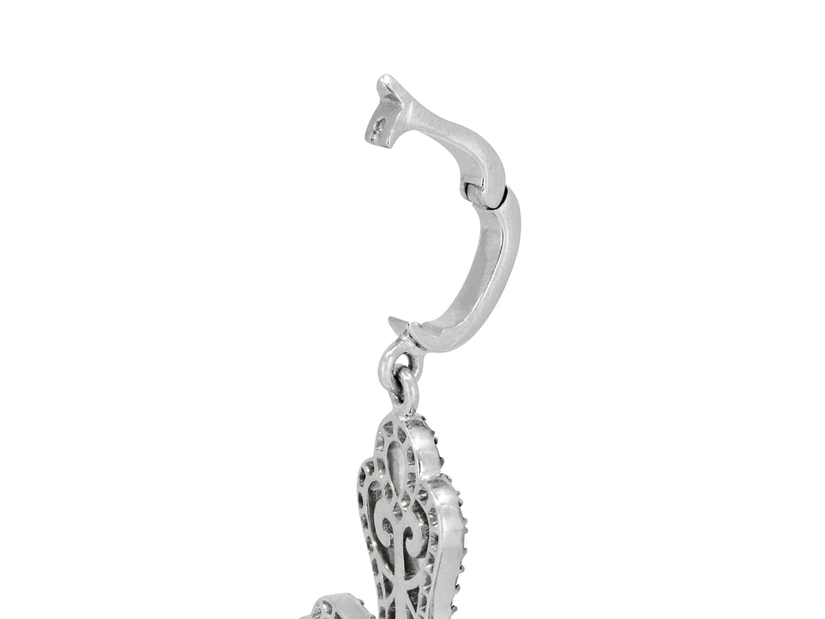 Close view of white gold diamond cross pendant bail