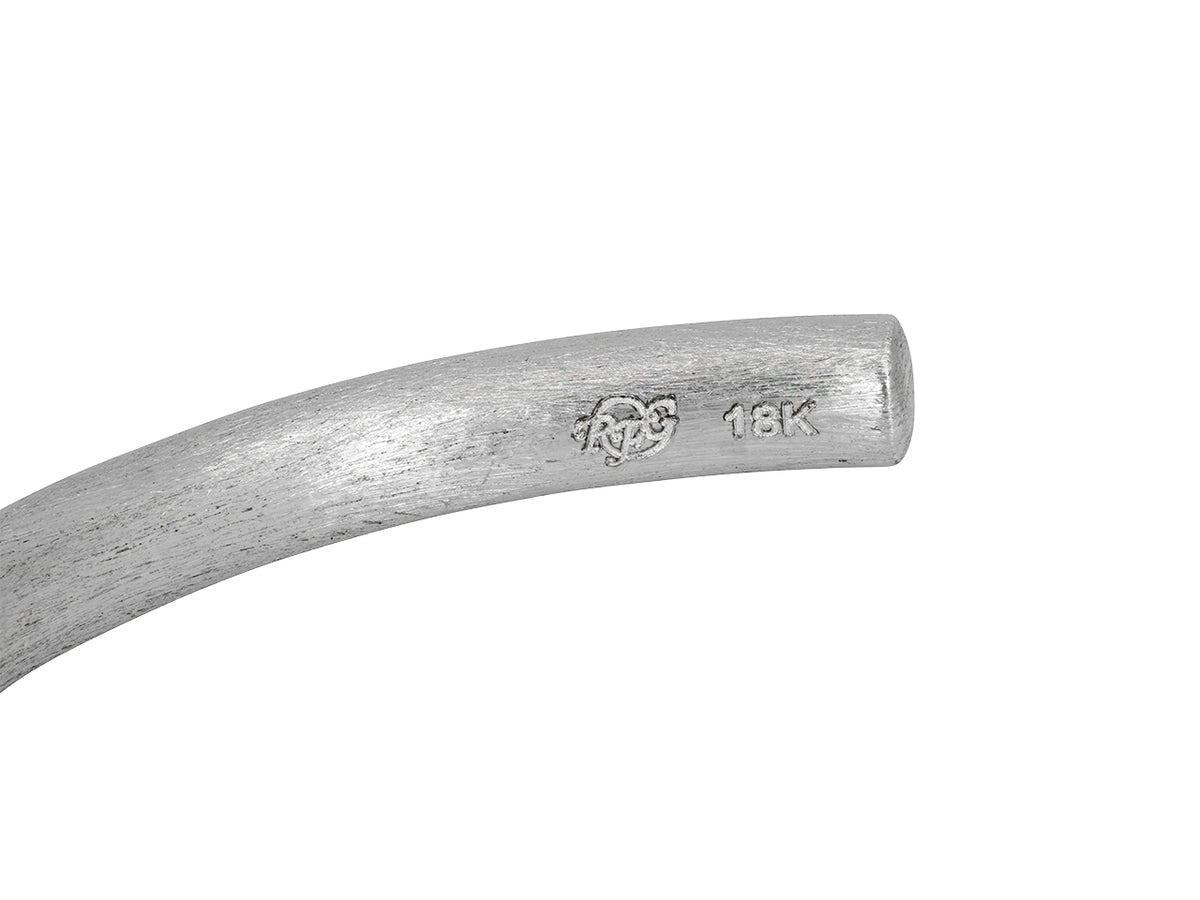 Closeup of textured 18K white gold earring with RFG hallmark