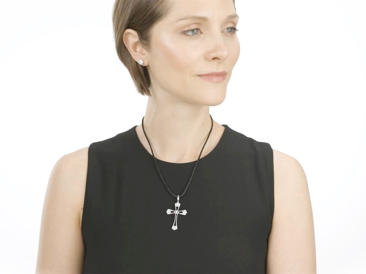 Woman wearing a white gold diamond filigree cross pendant necklace