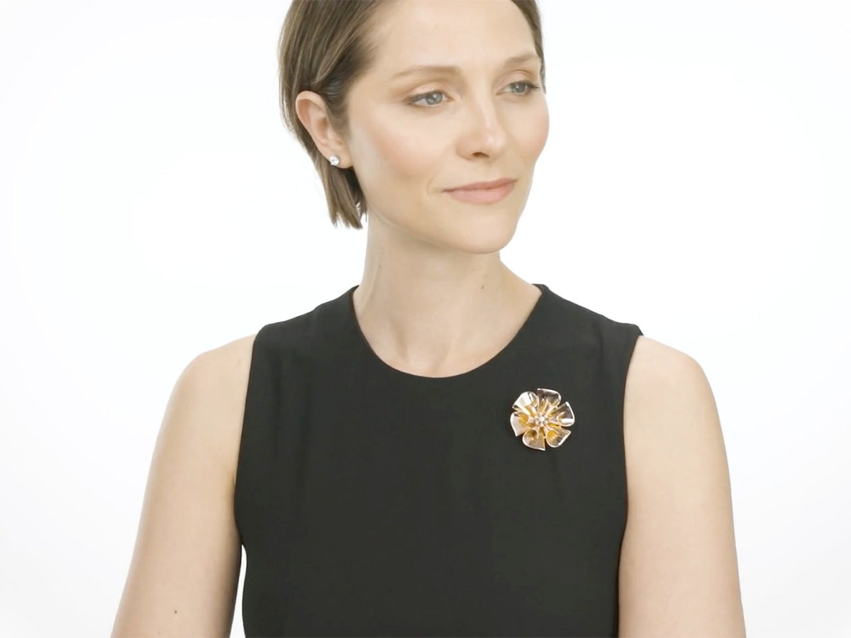 Woman wearing a rose gold flower brooch