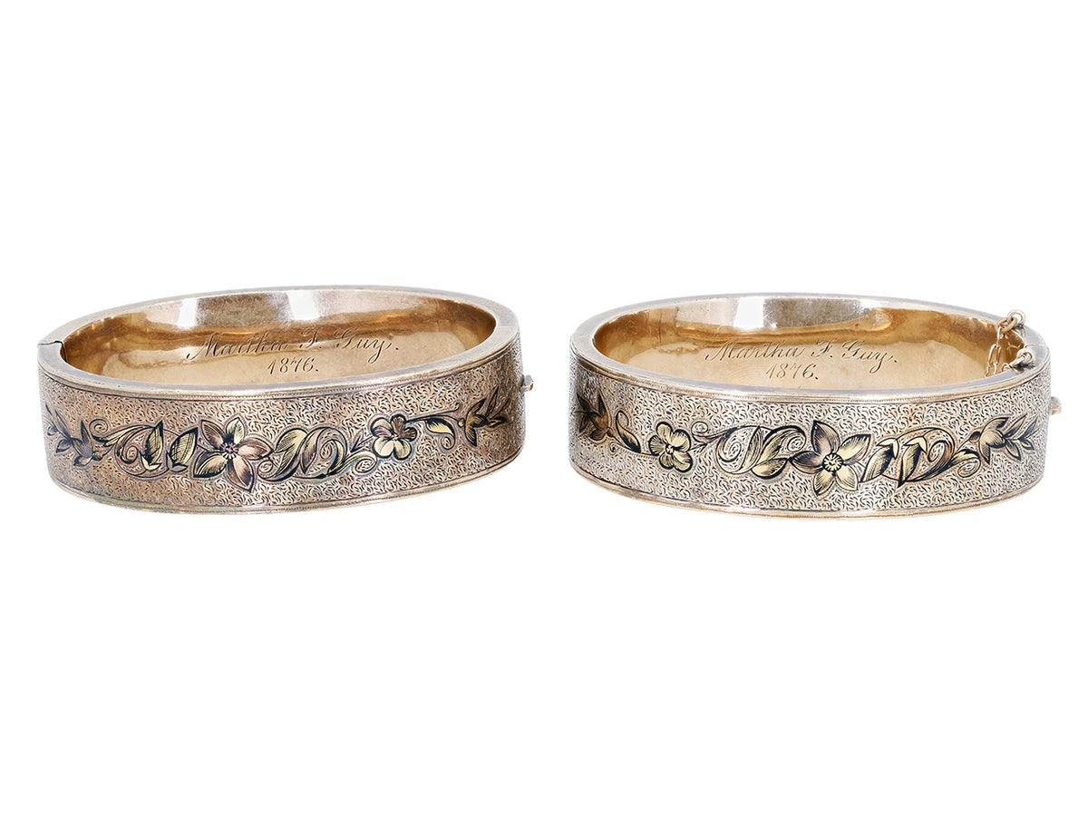Pair of antique 12K gold bangles with black enamel floral designs