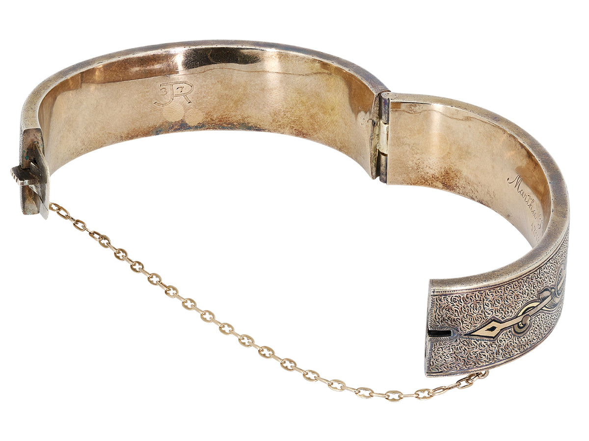 Antique 12K gold hinged bangle with black enamel foliate design