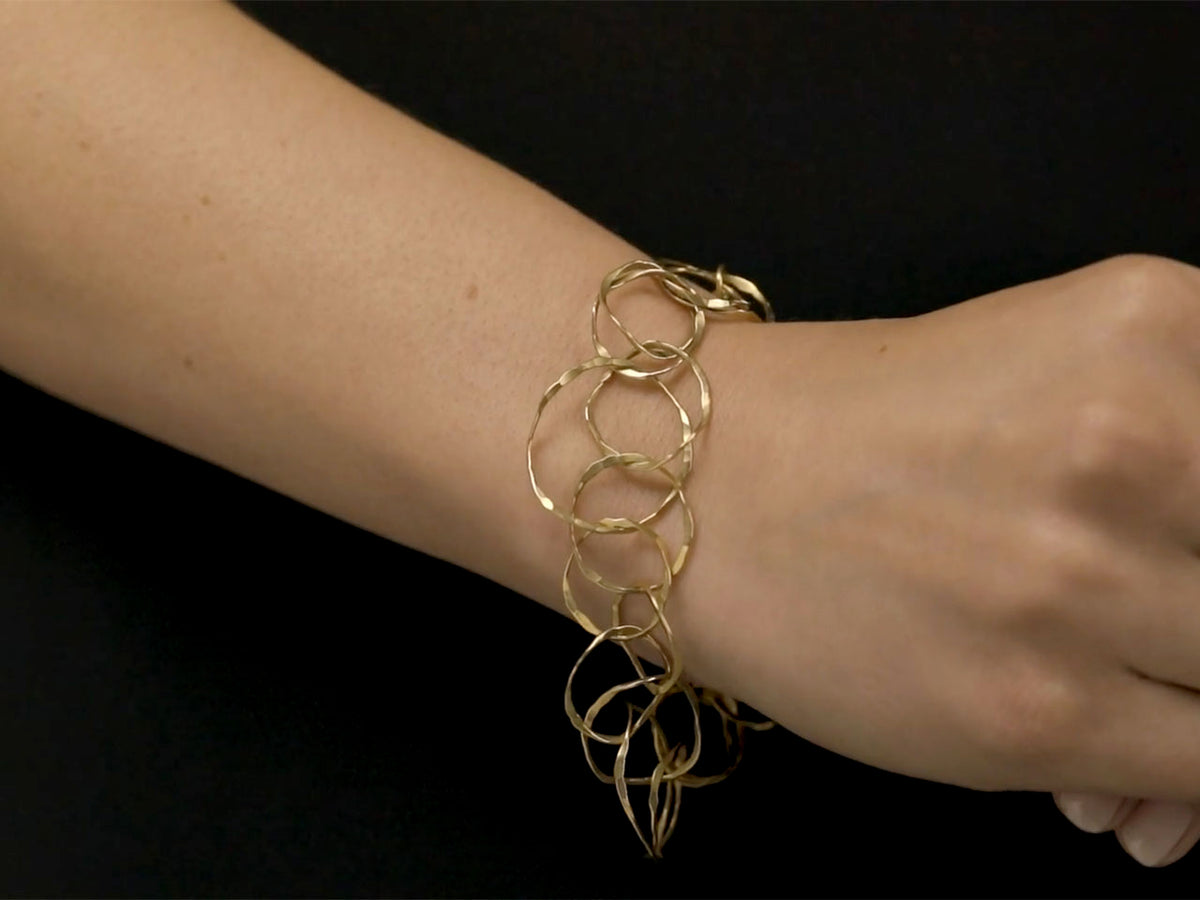 18K gold link bracelet worn on a wrist