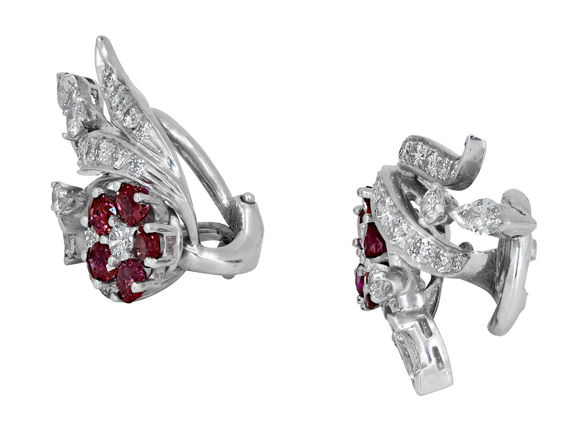 Angled view of platinum diamond and ruby flower earrings