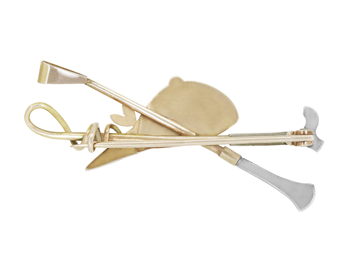 Gold and silver equestrian brooch with helmet and riding crop