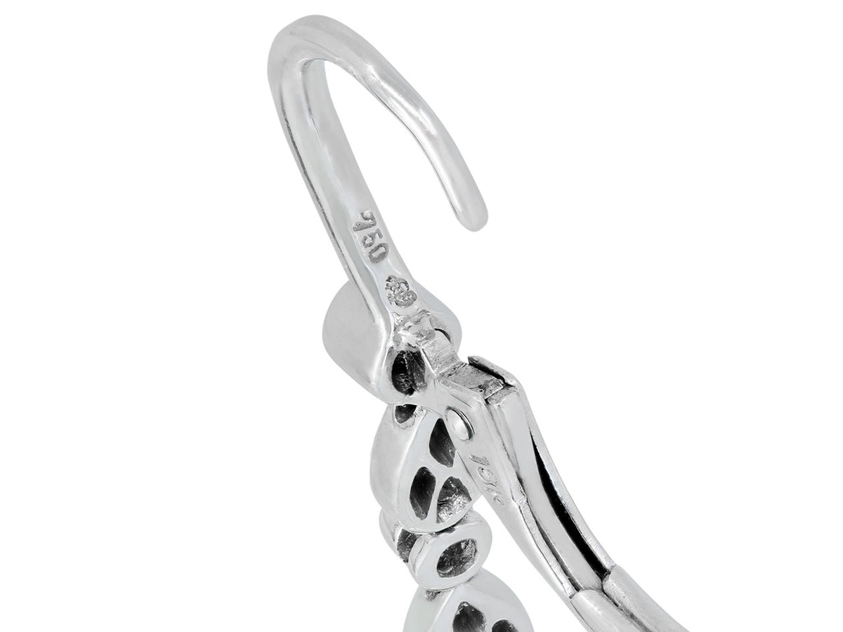Close-up of diamond-set 18K white gold earring clasp
