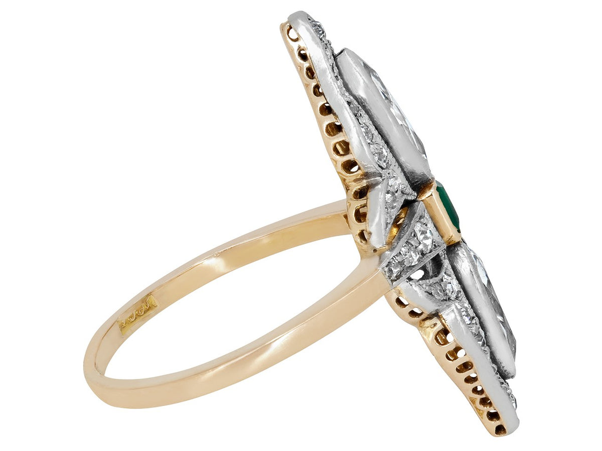Side view of an emerald and diamond ring in platinum over 18K gold