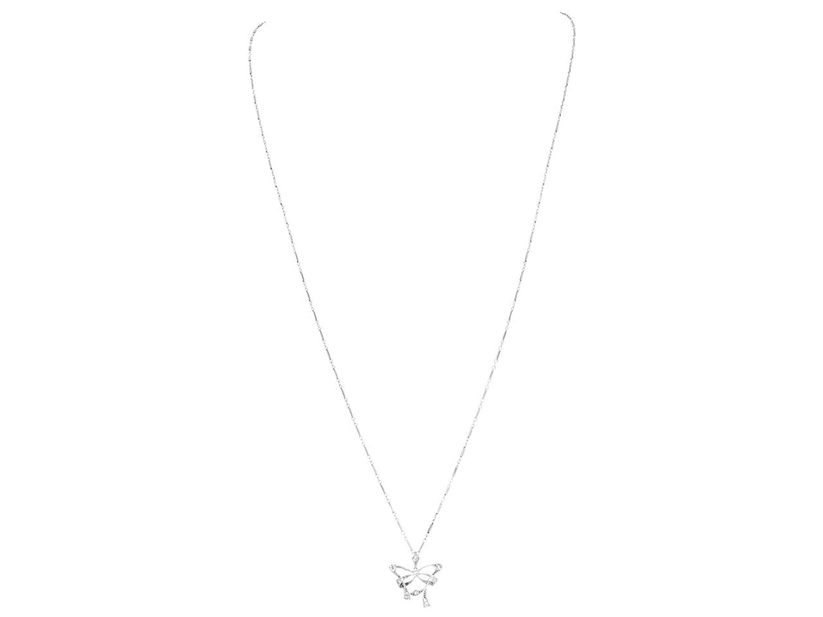 Platinum bow pendant necklace with diamond accents