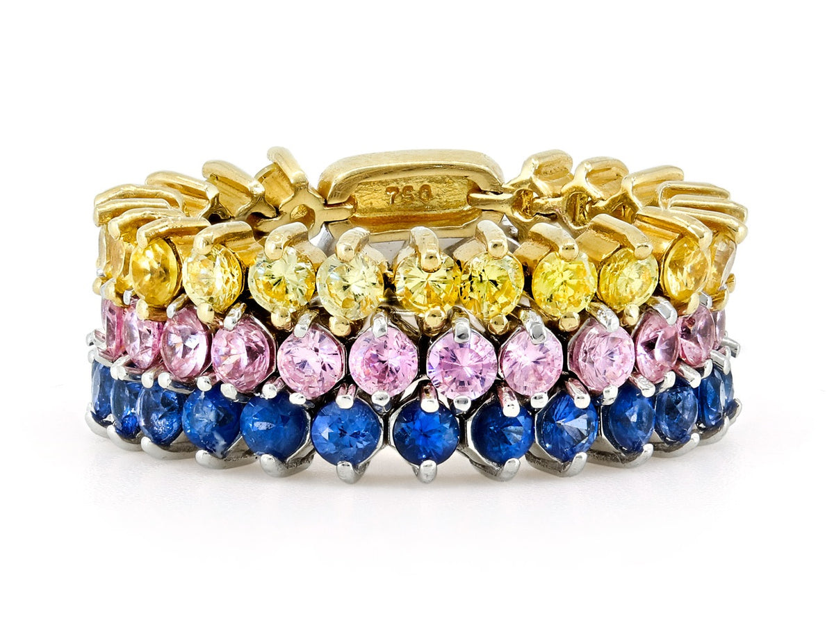 Three flexible gold bands with yellow pink and blue sapphires