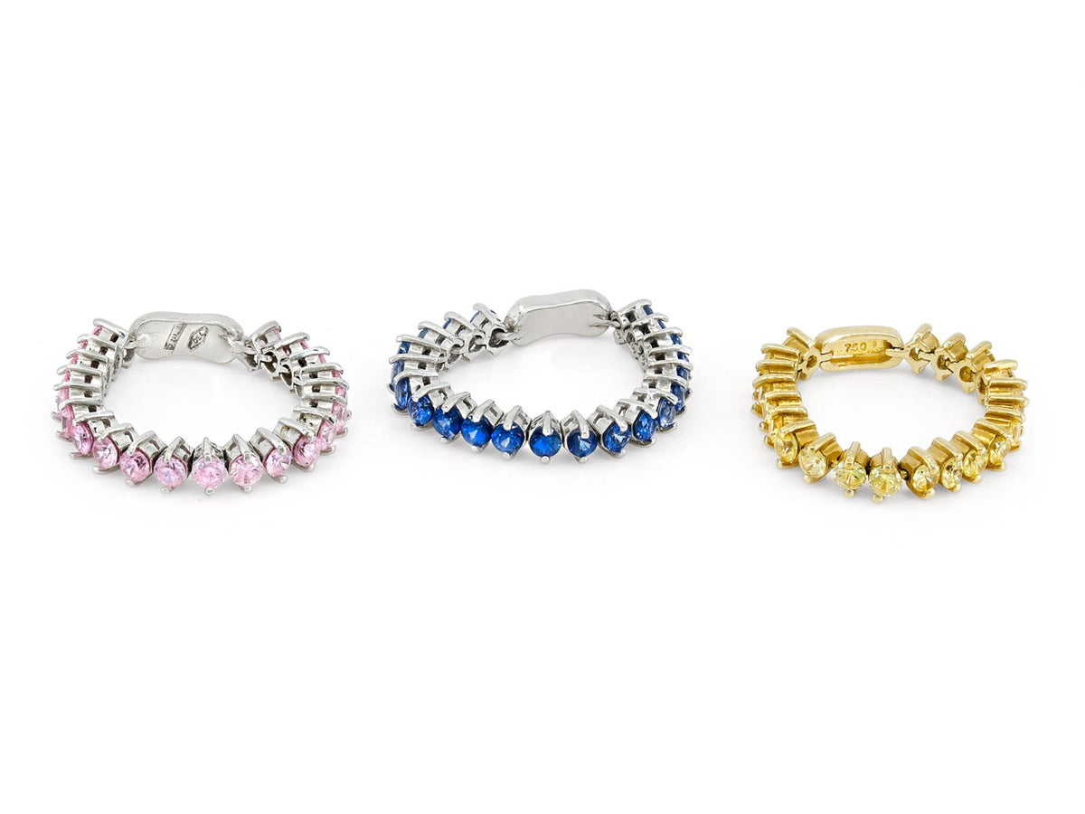 Three flexible 18K gold bands with pink blue and yellow sapphires
