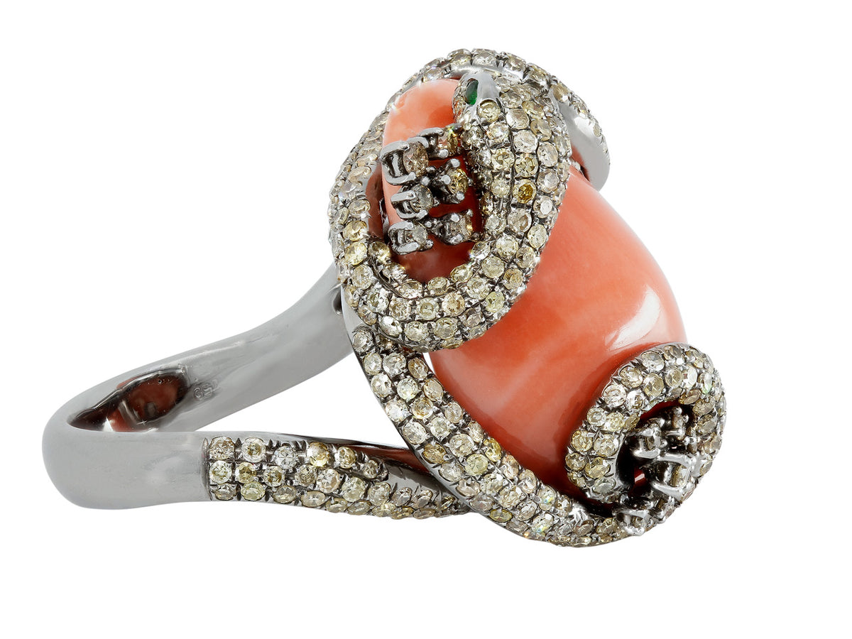 Coral ring with diamond set snake and emerald eyes