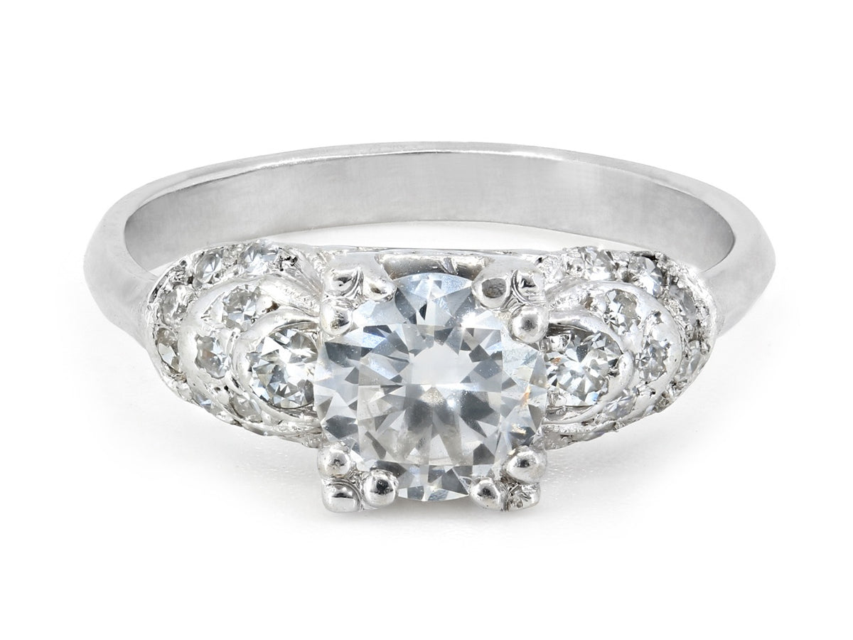 Platinum ring with central diamond and stepped diamond shoulders