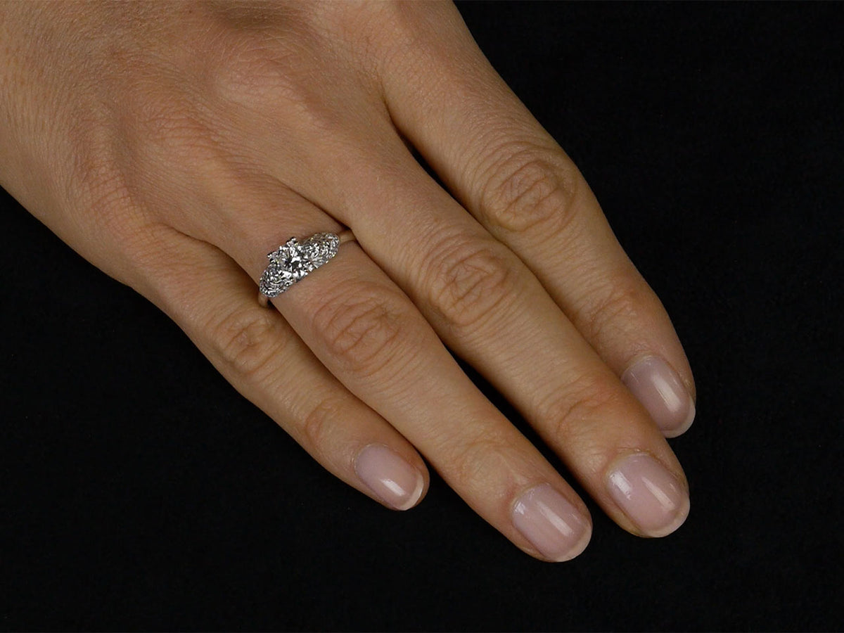 Diamond ring with stepped shoulders worn on hand