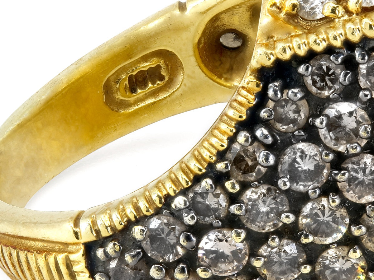 Close up of 18K gold ring with pavé diamonds