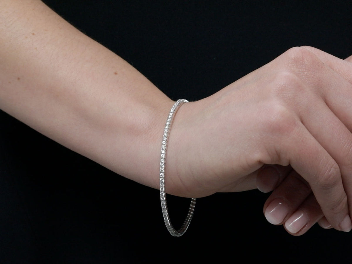 Diamond bangle bracelet in white gold on a wrist