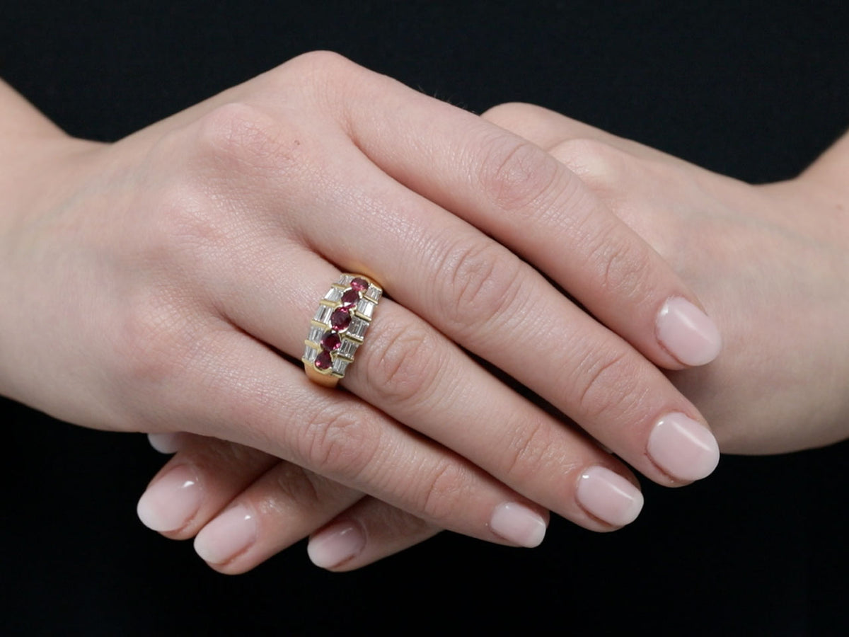 Ruby and baguette diamond ring worn on a hand
