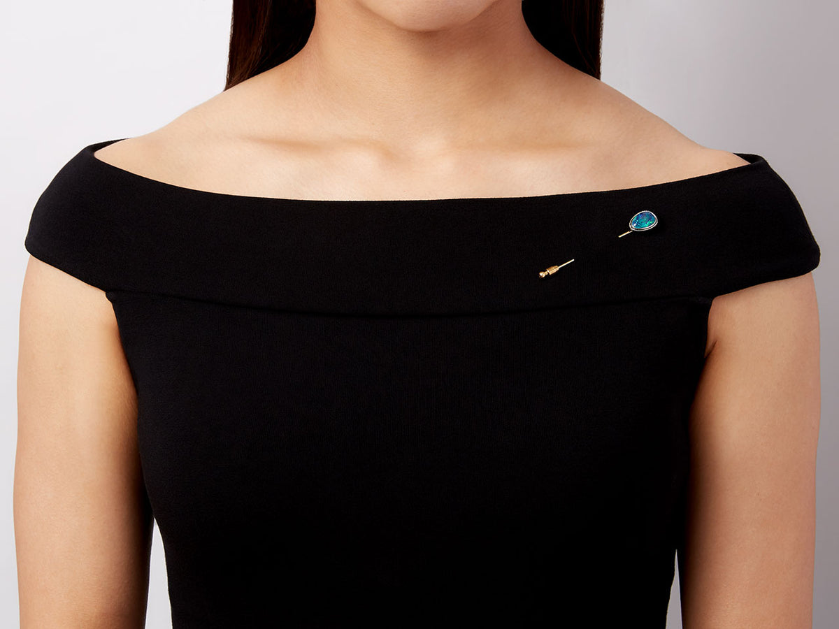 Black opal stick pin worn on a black dress