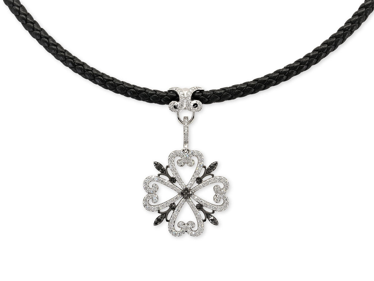 White diamond quatrefoil pendant on black braided cord