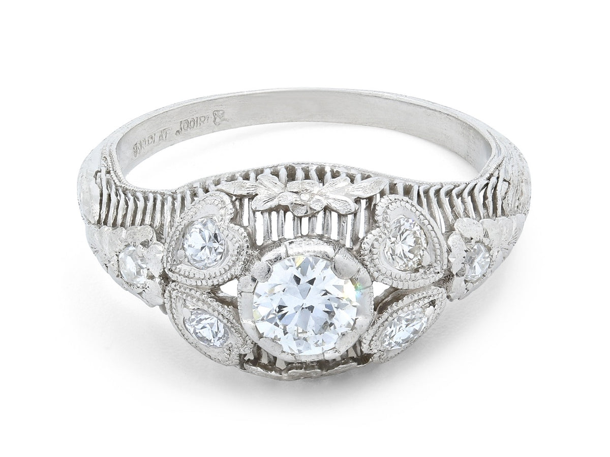 Platinum Art Deco ring with central diamond and foliate details