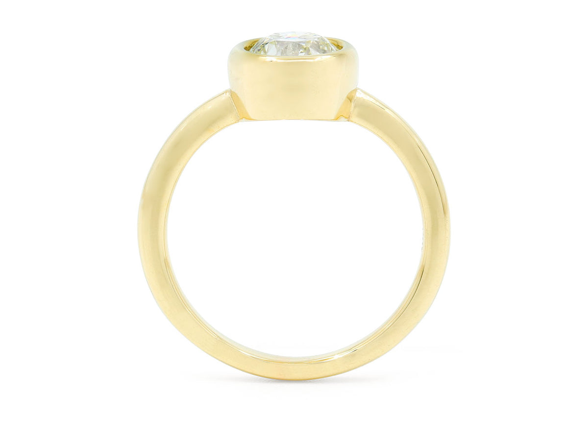Side view of an 18K gold bezel set diamond ring