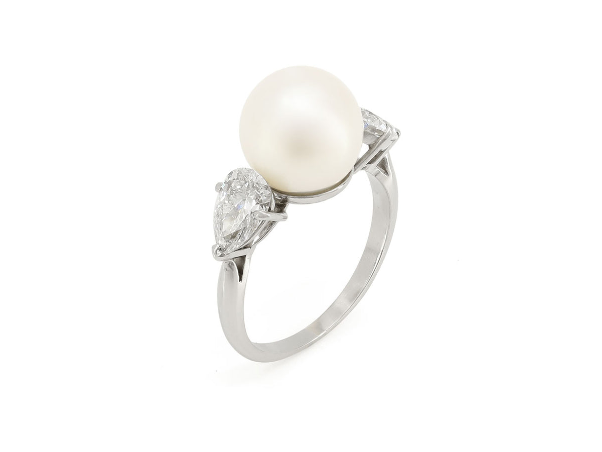 Platinum ring with an Akoya pearl and two pear shape diamonds