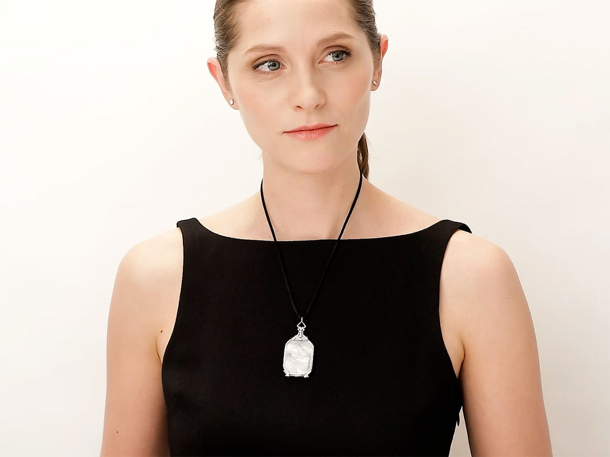 Woman wearing a platinum lorgnette pendant necklace