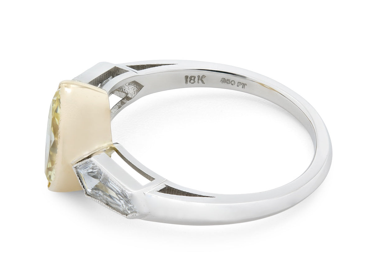 Side view of platinum ring with yellow diamond and kite diamonds
