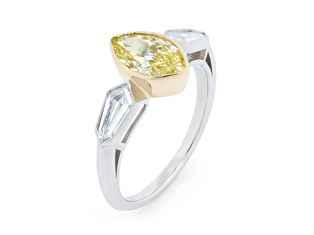 Platinum ring with bezel set yellow marquise diamond and side diamonds