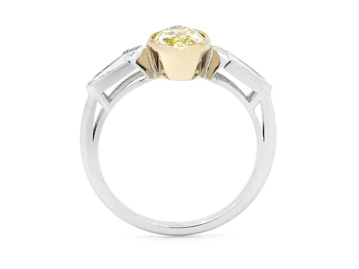 Side view of a yellow diamond bezel ring in platinum and gold