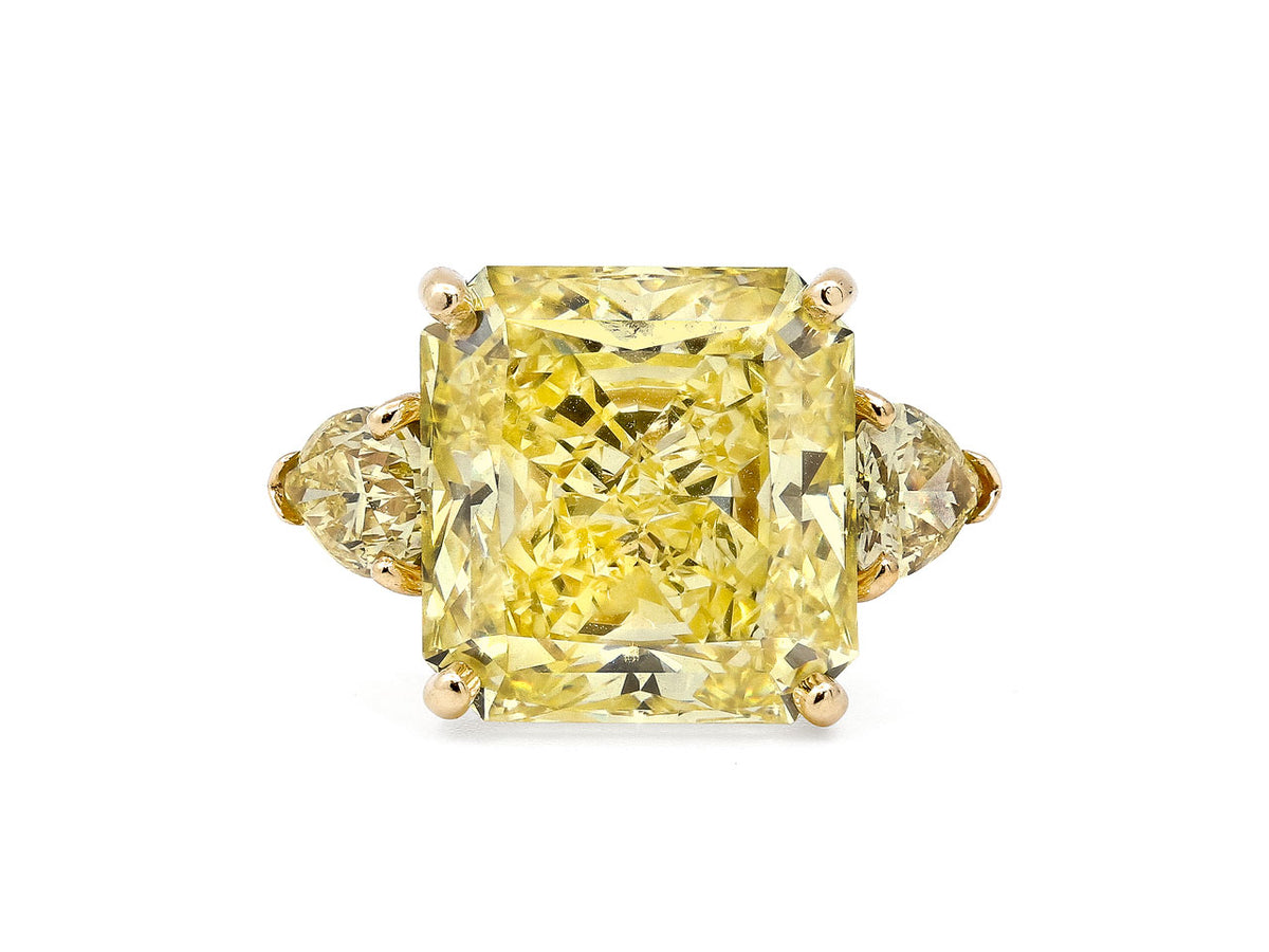 Yellow diamond ring with radiant center and pear side stones