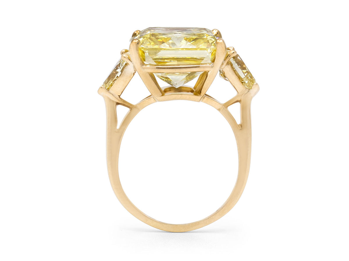 Side view of a gold ring with a large yellow diamond