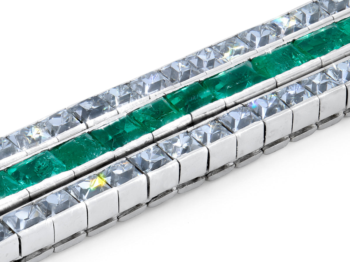 Close up of a three row emerald and diamond bracelet