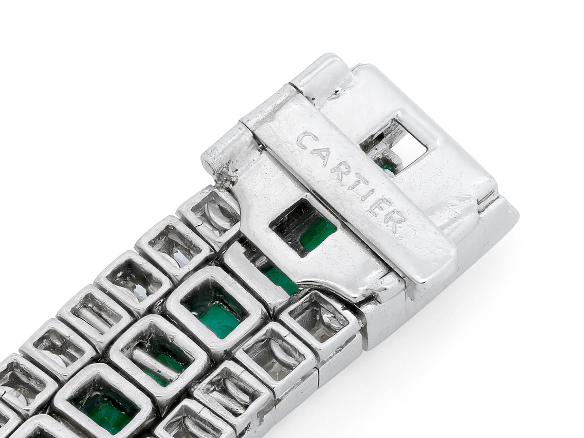 Close-up of platinum bracelet links with emerald accents
