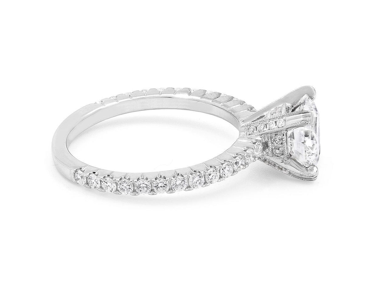 White gold diamond solitaire ring with pavé band