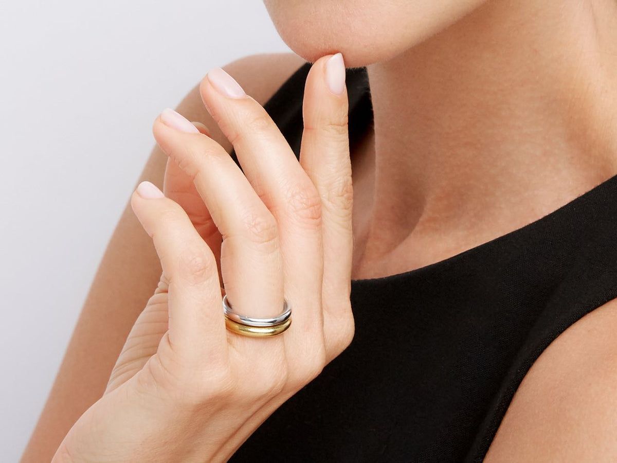 Woman wearing platinum and yellow gold wedding bands