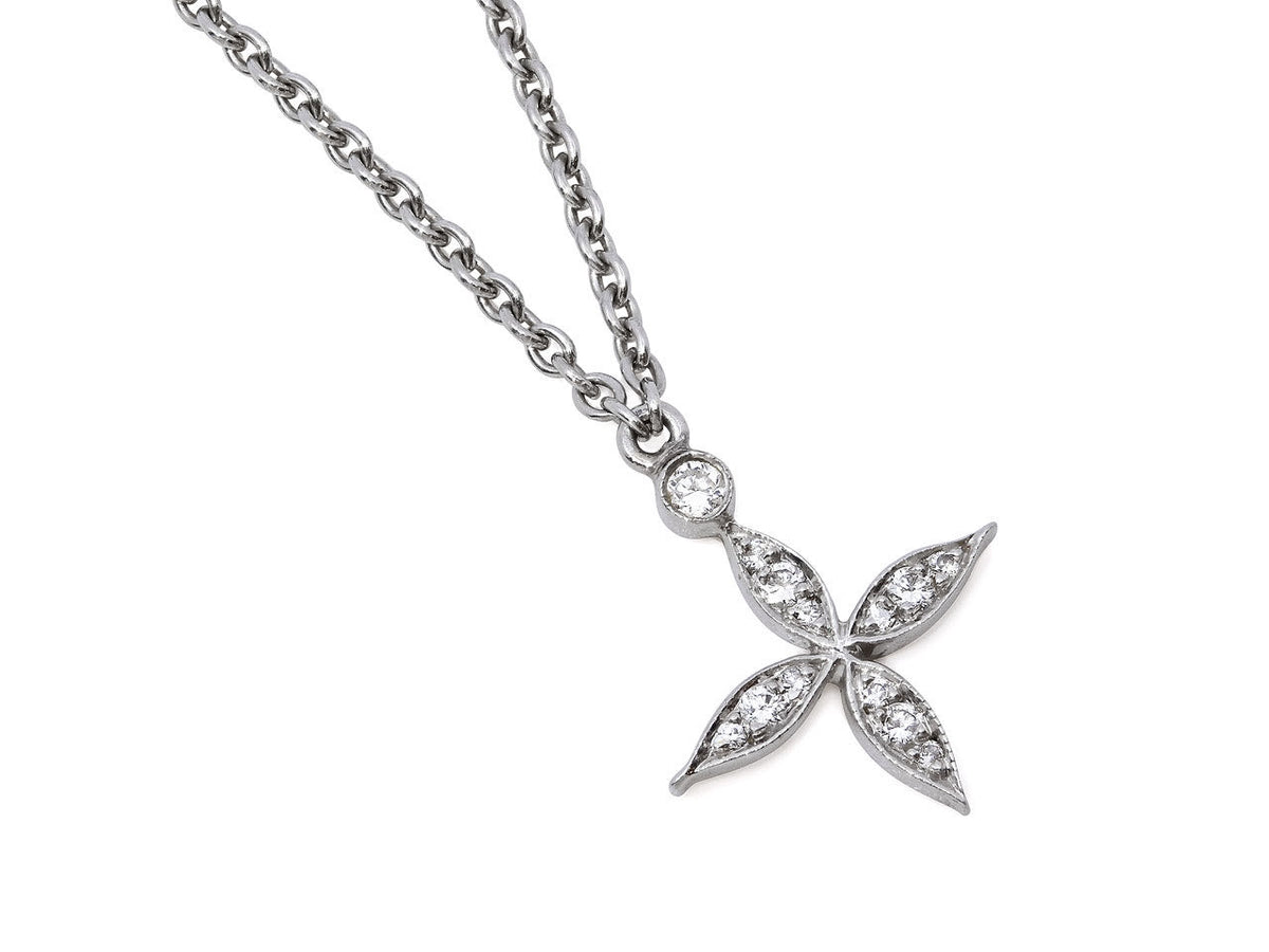 Platinum diamond flower pendant on a fine link chain