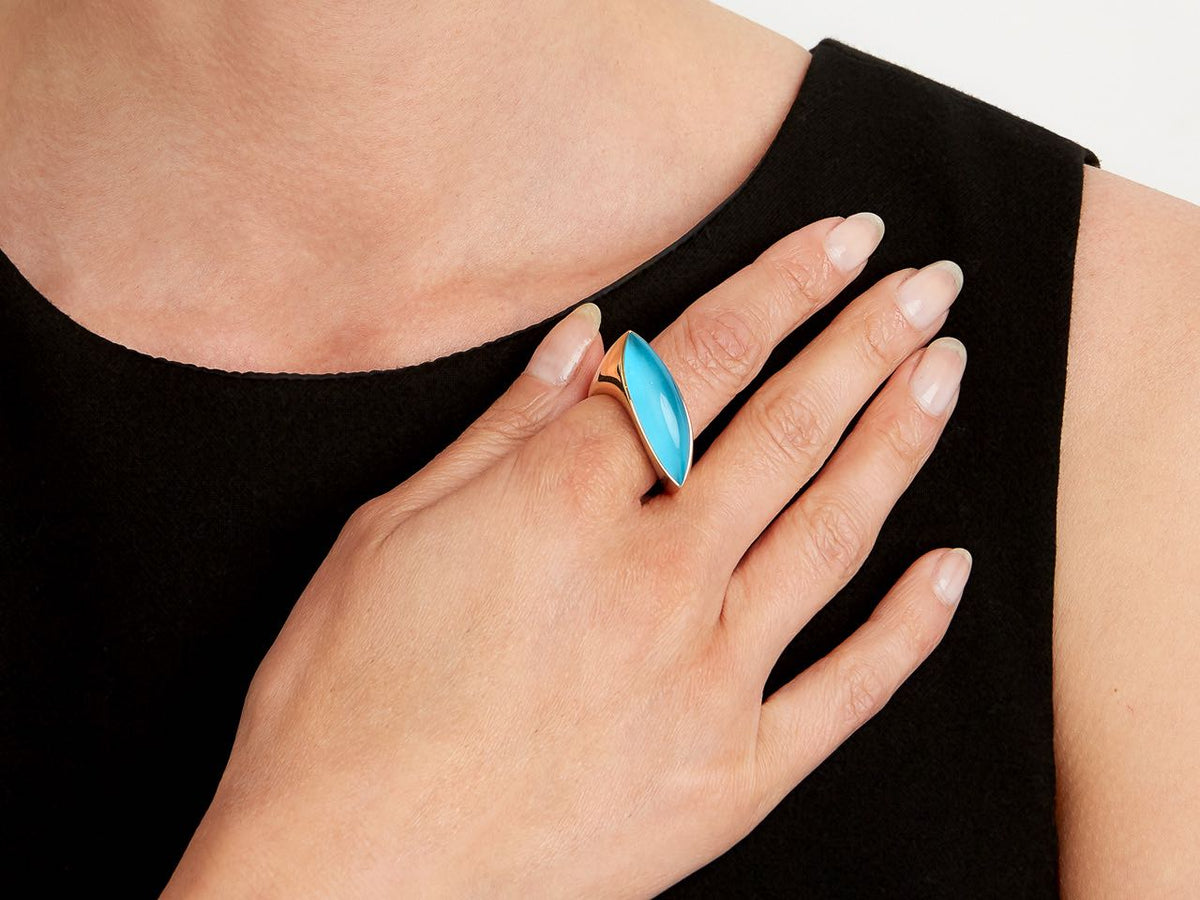 Marquise turquoise and gold ring worn on hand