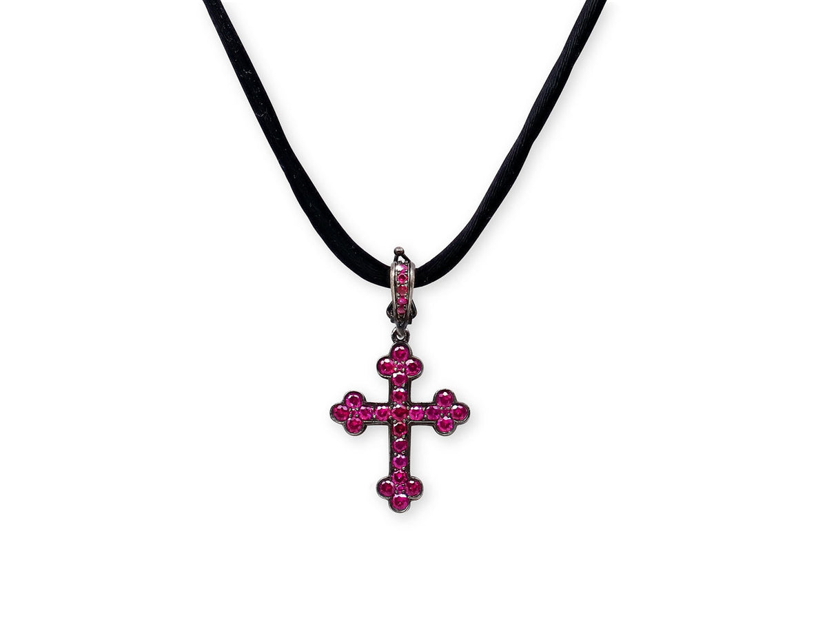 Ruby cross pendant on a black silk cord