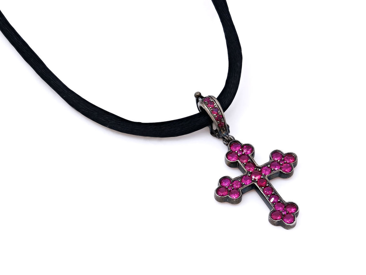 Ruby cross pendant on a black silk cord