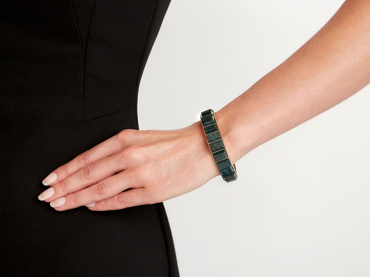 18K gold bangle with rectangular bloodstones on a wrist