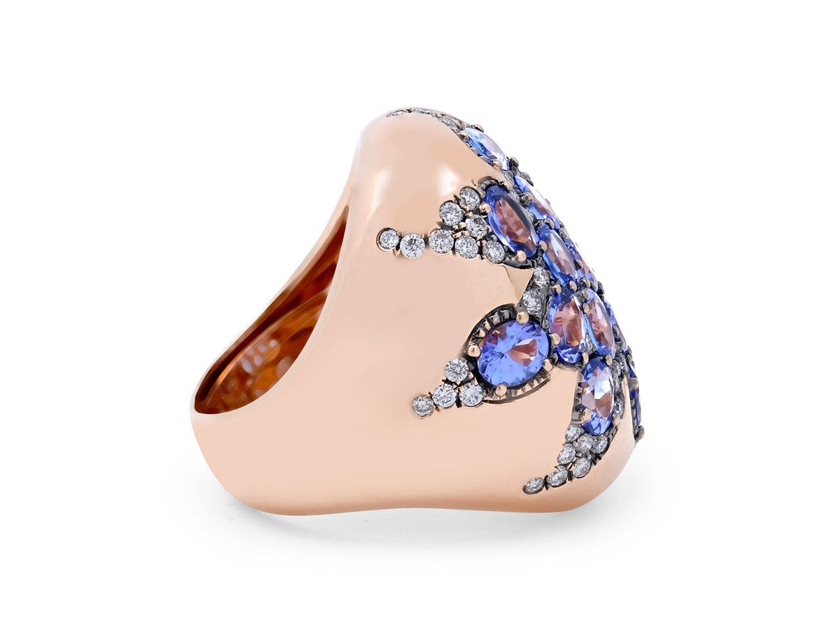 Side view of an 18K rose gold ring with oval purple blue tanzanites and diamonds