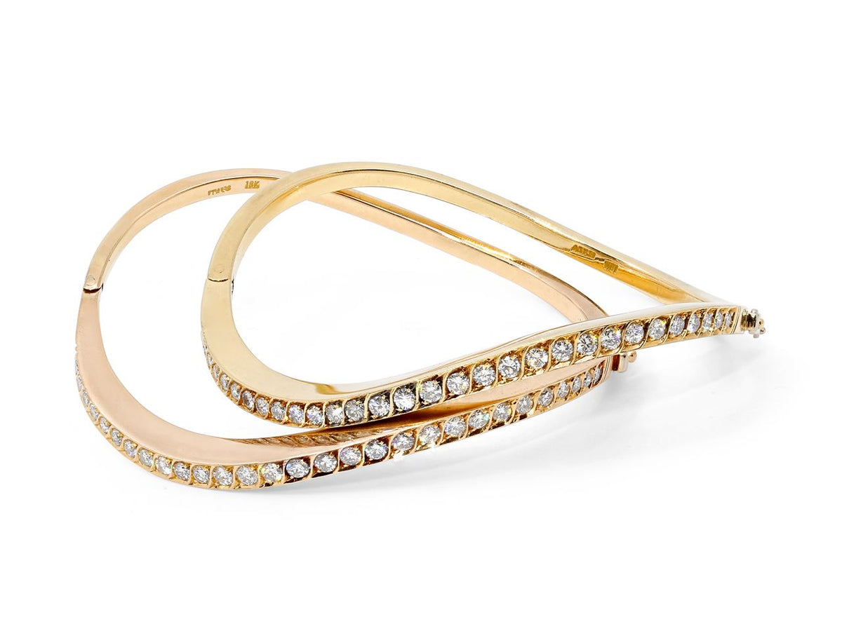 Pair of wave shaped gold bangles with rows of diamonds