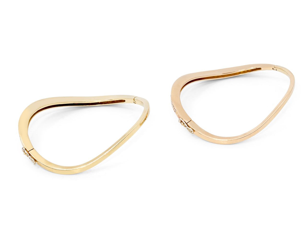 Pair of 18K yellow and rose gold wave bangles