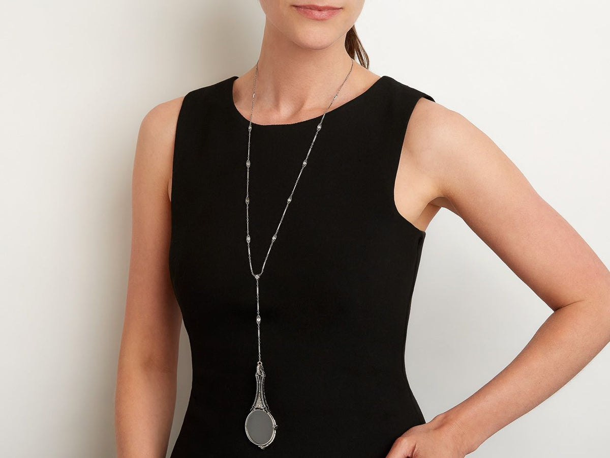 Long white gold lorgnette necklace on model