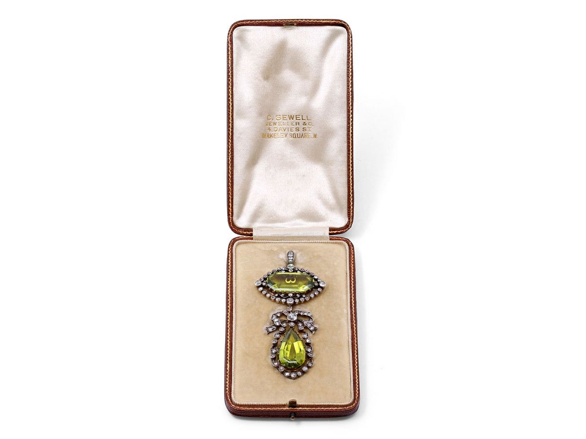 Antique peridot and diamond pendant in an open box