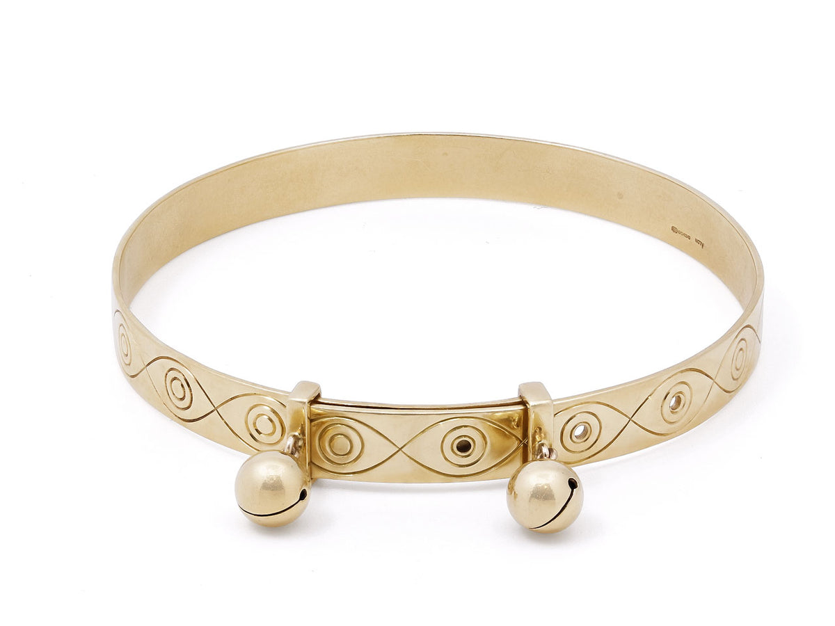 Polished 18K gold bangle with overlapping clasp and bells